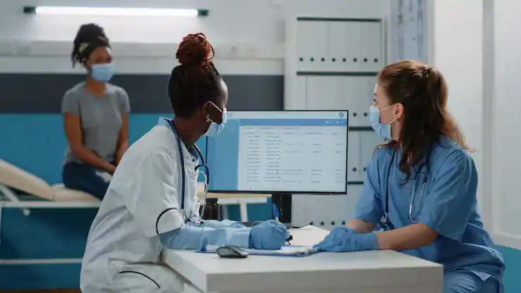 Medical staff reviewing billing data in clinic